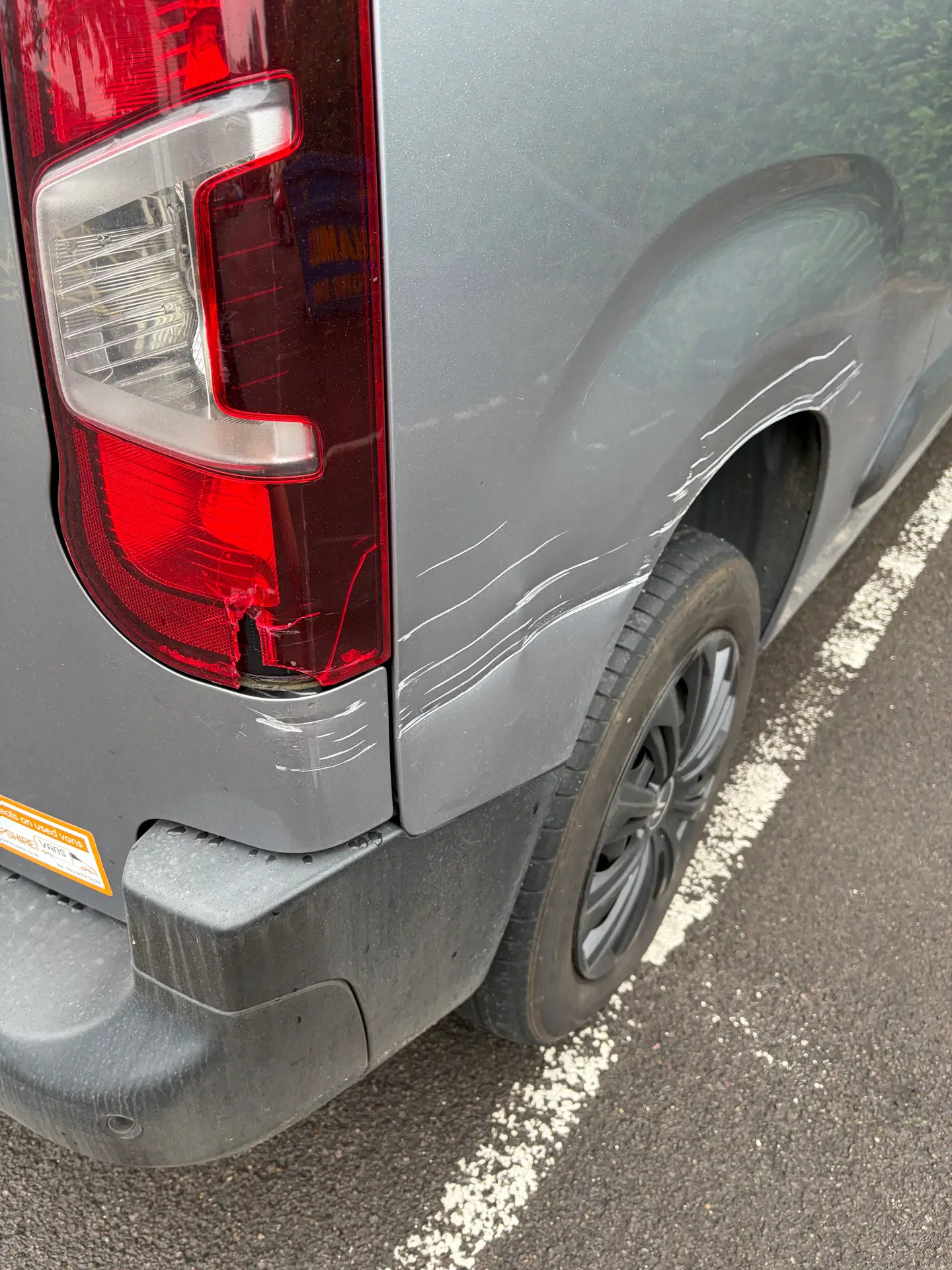 Scratches along the rear side panel of a grey Citroën Berlingo van before repair