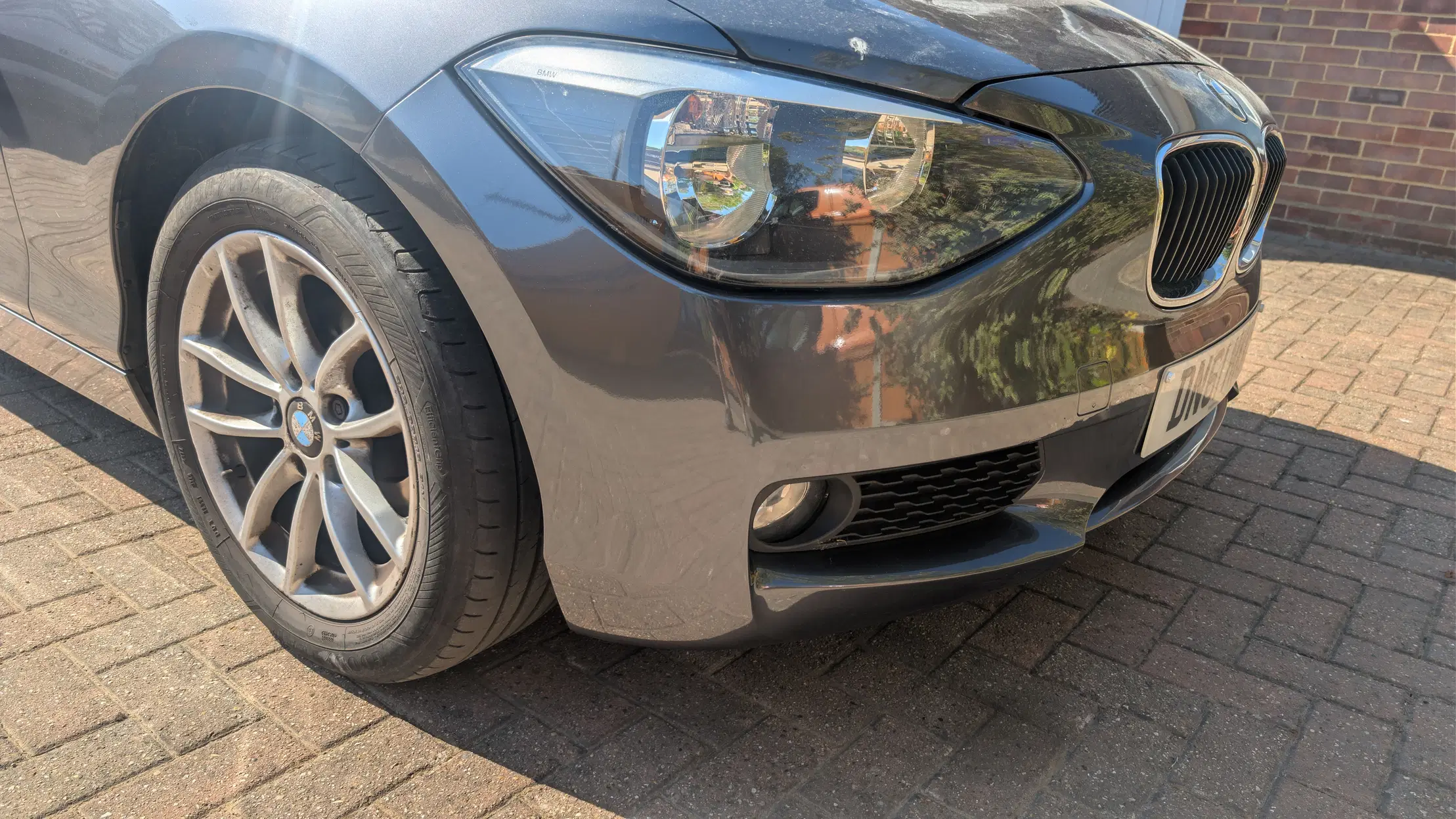 Grey BMW front bumper after scuff repair