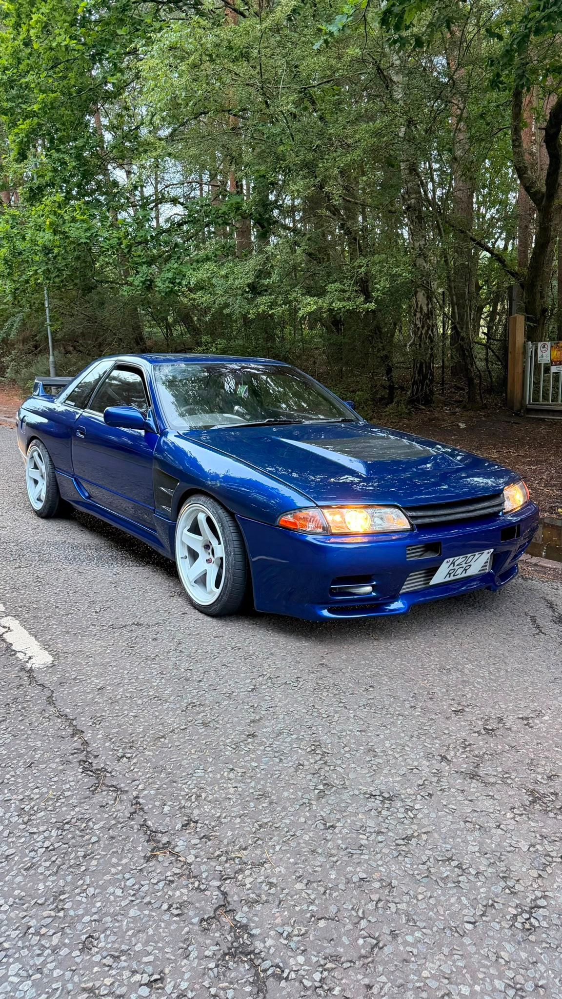 Nissan Skyline R32 in blue after its full respray, front view outdoors