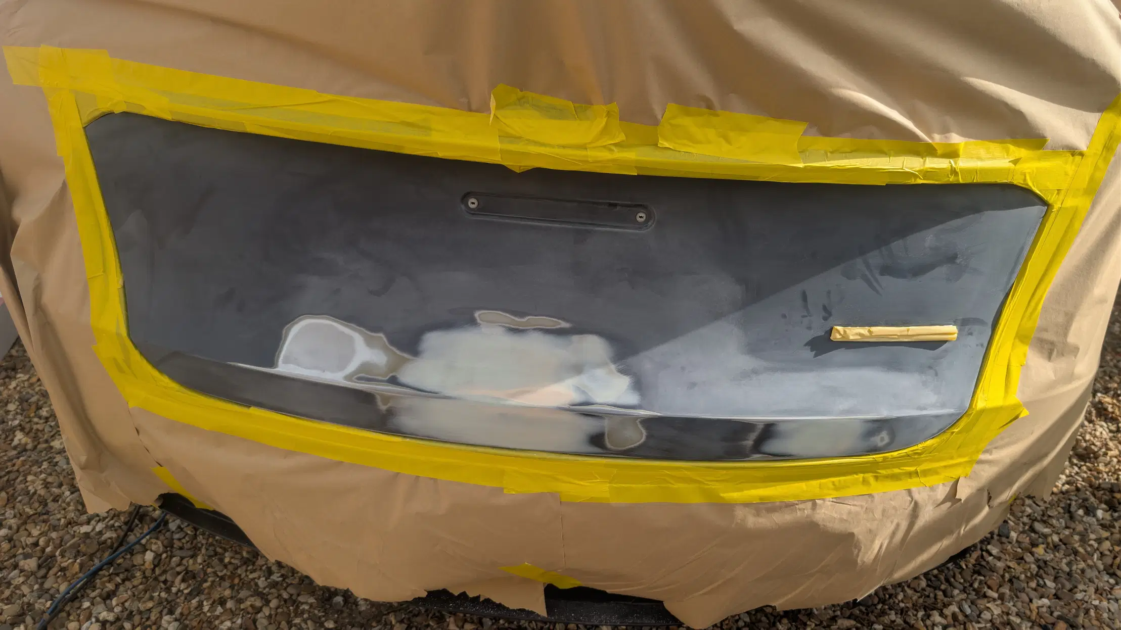 Tesla rear bumper masked and prepared for repair