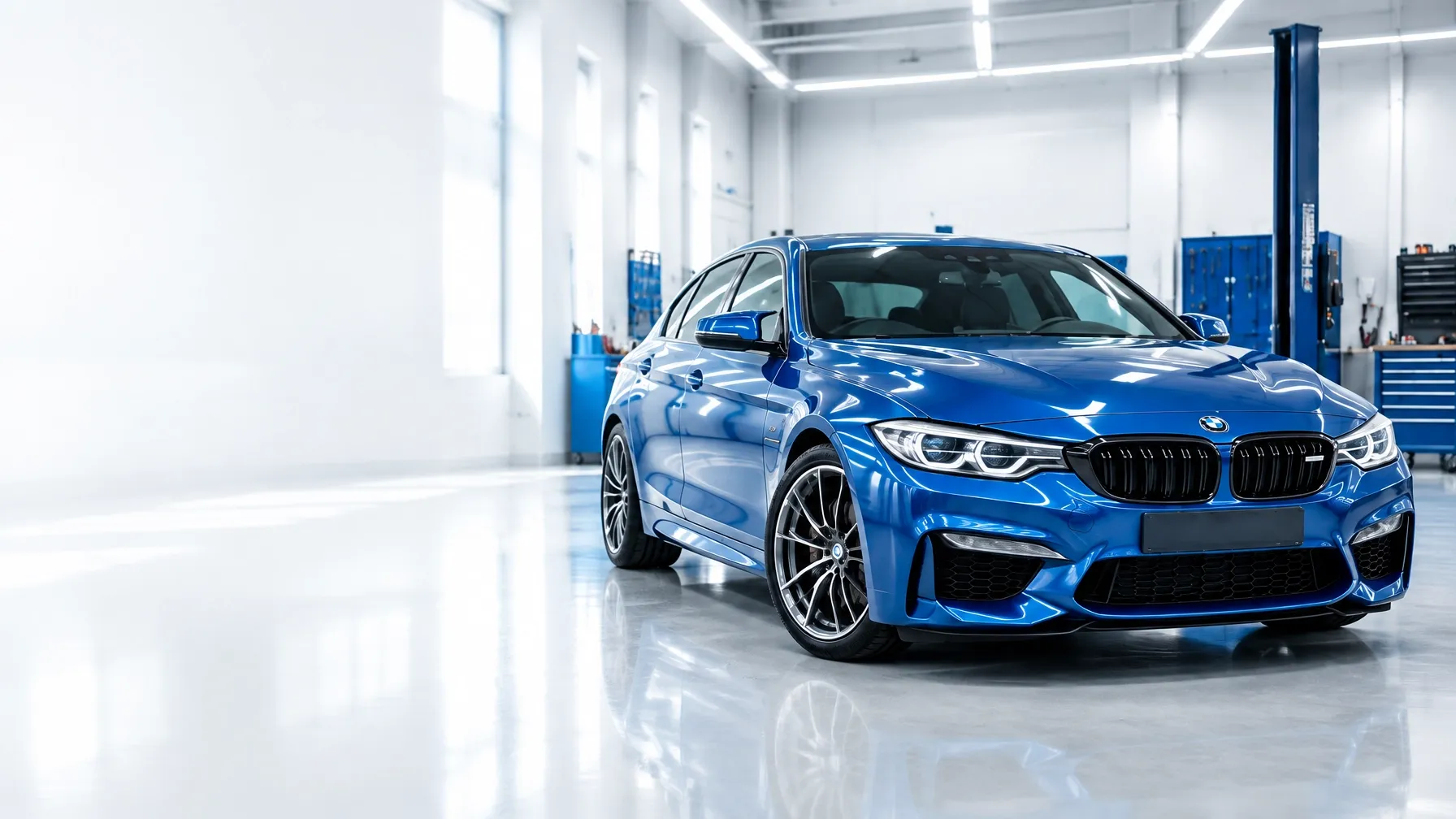 Blue car in a bright, professional vehicle repair workshop